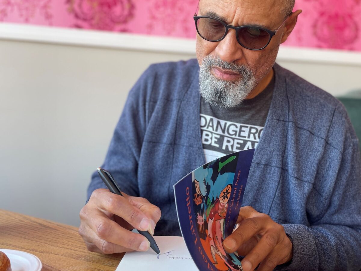 Poet Tim Seibles signs a copy of his book, "Voodoo Libretto" in Norfolk